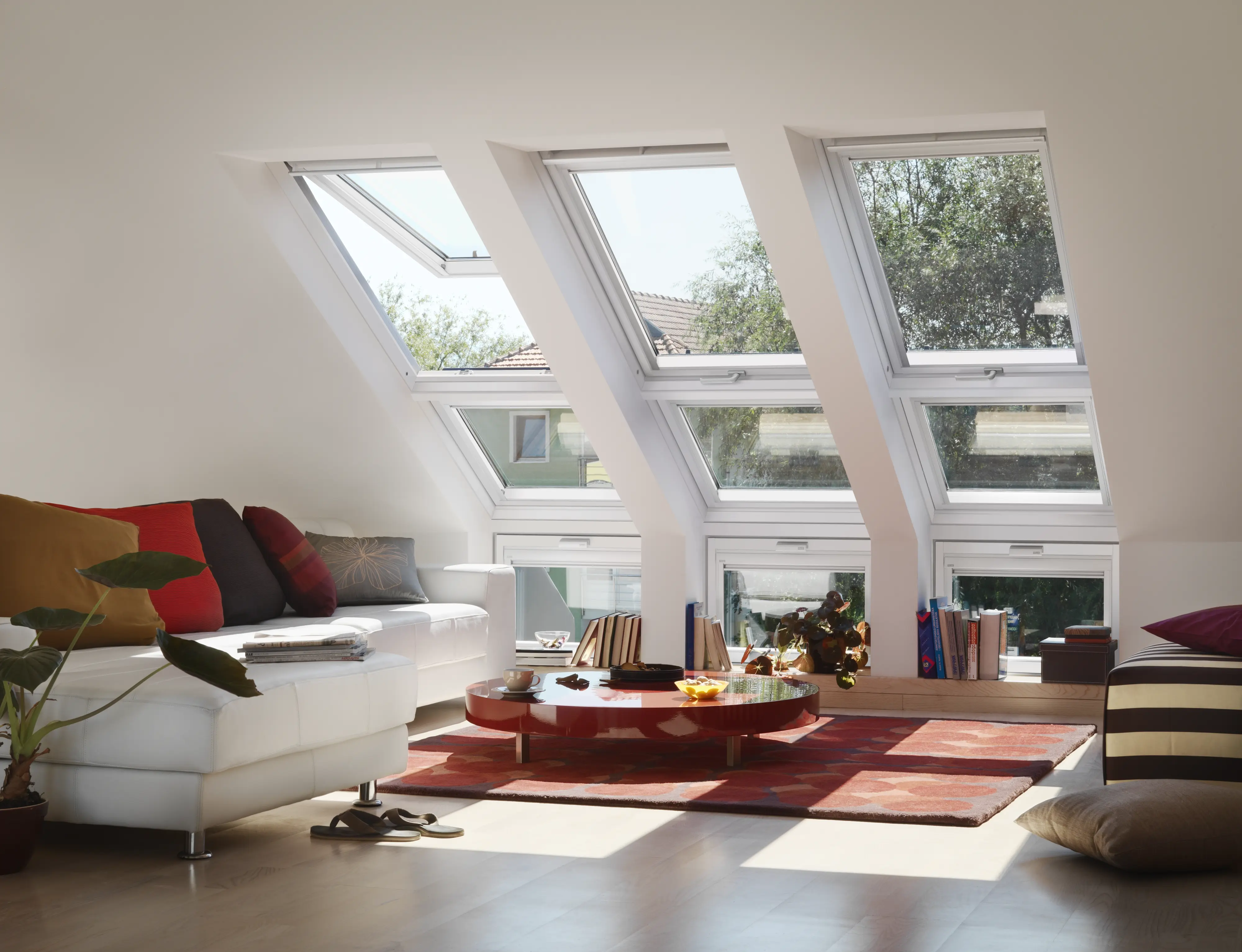 Modern living room with a large VELUX window, enhancing the space with natural light and a stylish couch